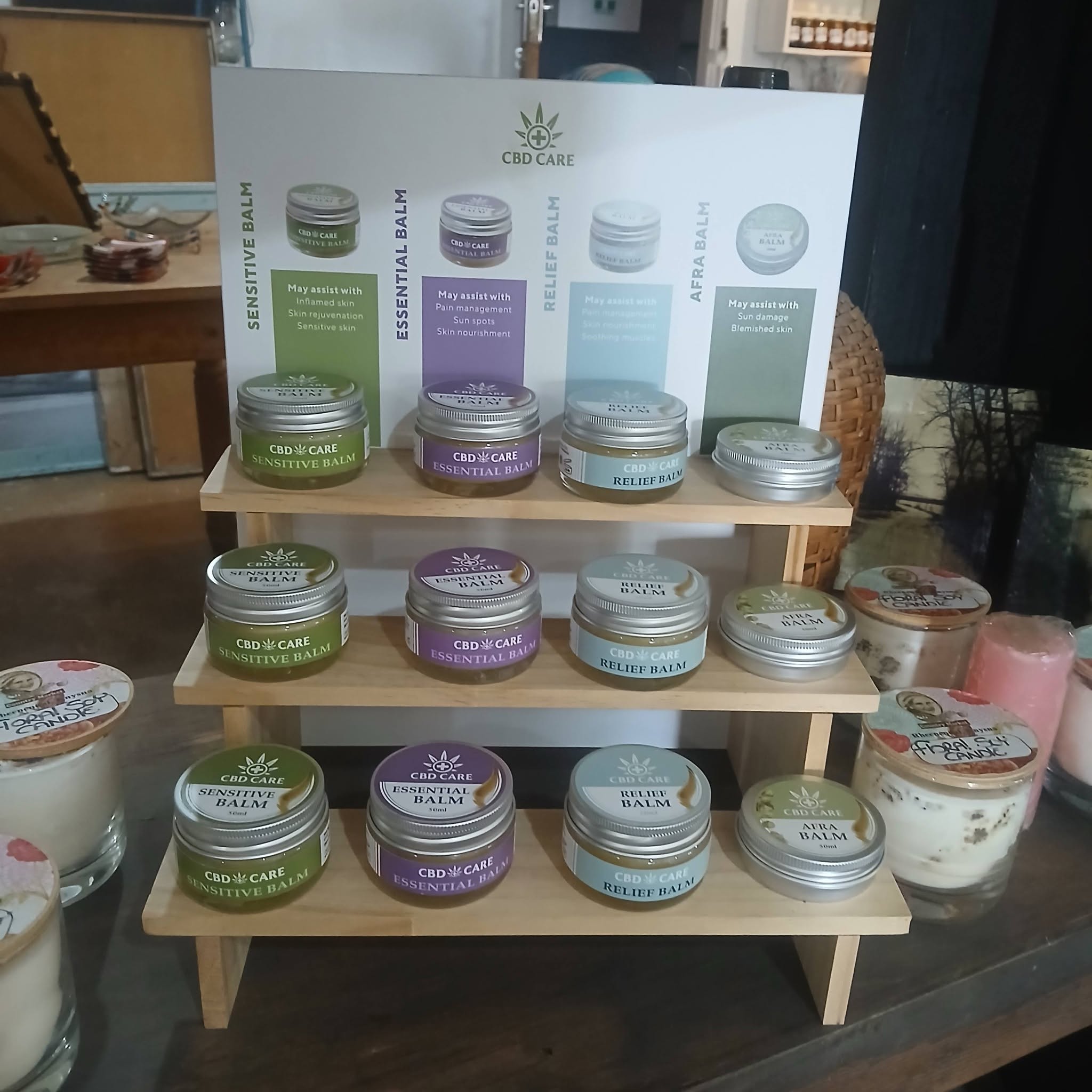 CBD Care balms and soy candles on display