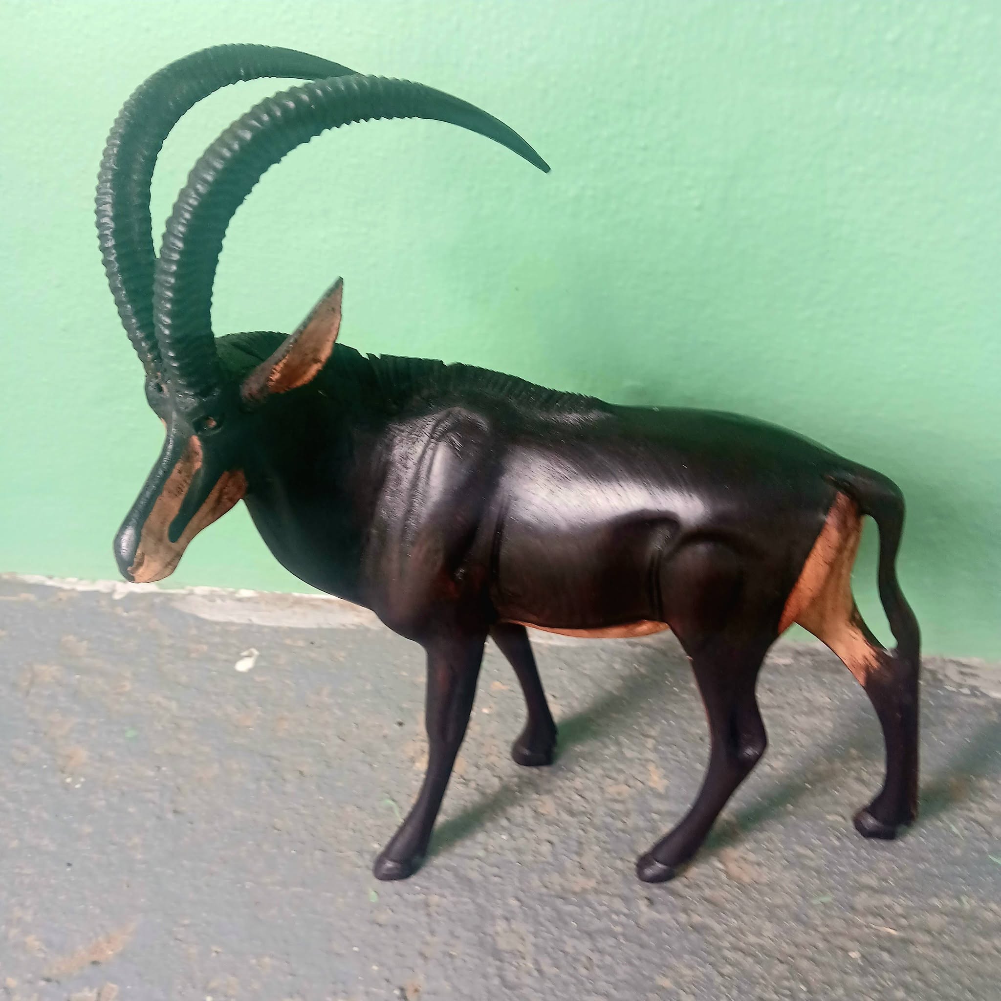 Hand-carved wooden antelope sculpture